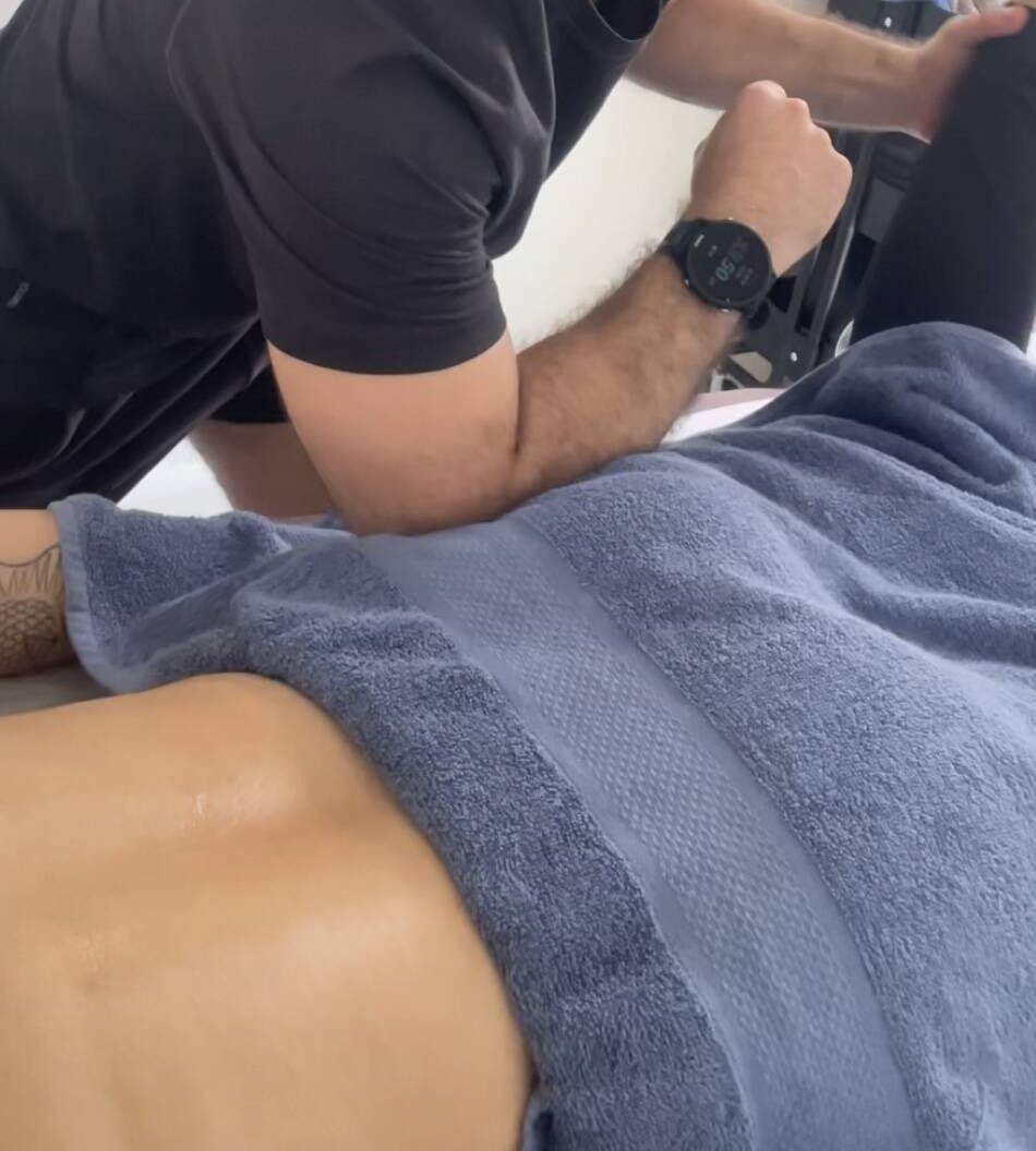 Chris working on a client's back with his forearm during a deep tissue massage